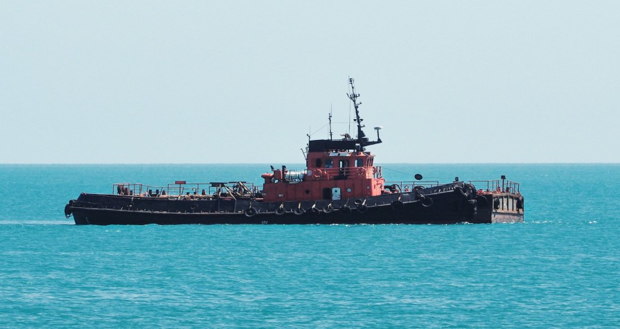10-09-2021-7740-side-view-tugboat-towboat-blue-sea-water-sky-background.jpg